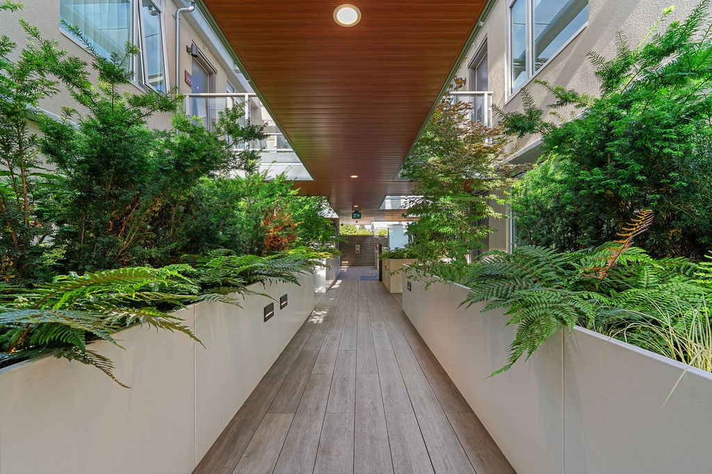 Landscaped interior courtyard walkway at 1331 Ambleside Residences
